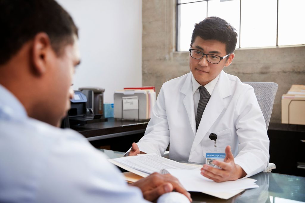 doctor talking to male patient