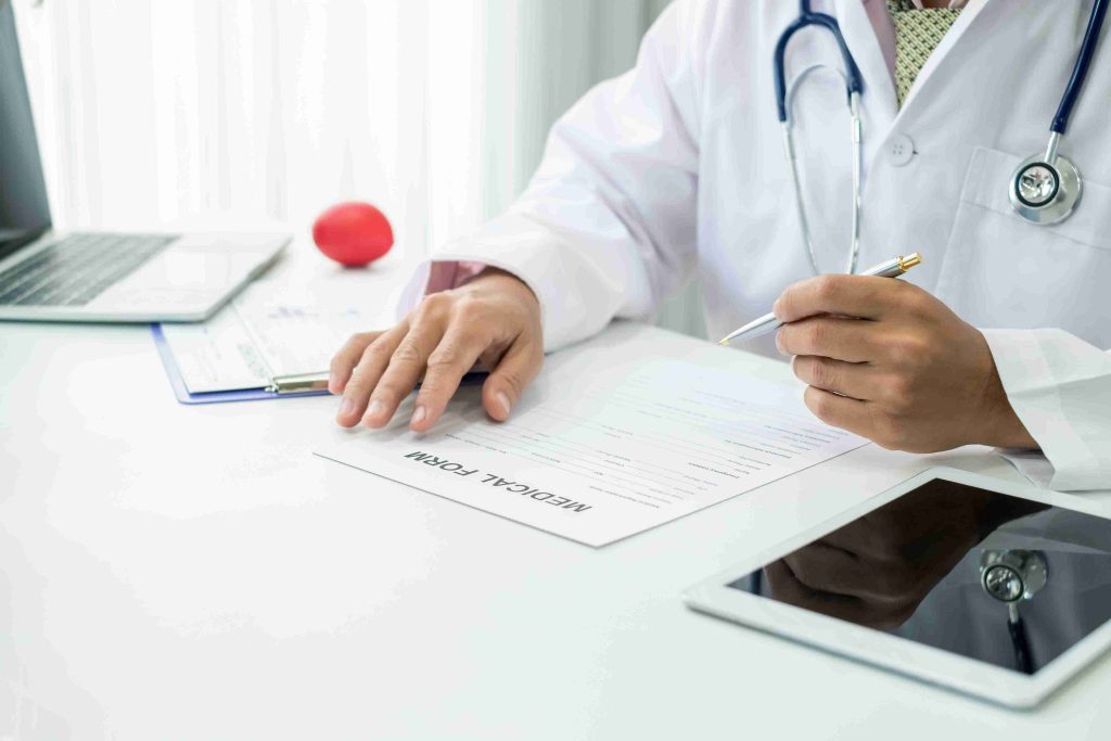 doctor filling out patient information