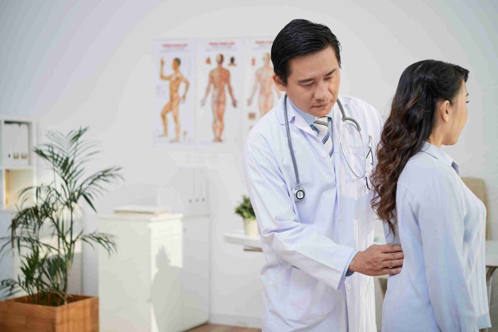 male doctor examining a female patient