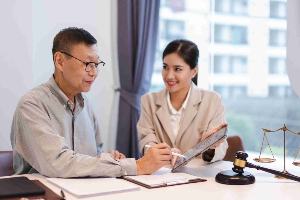 elderly man speaking with a female lawyer