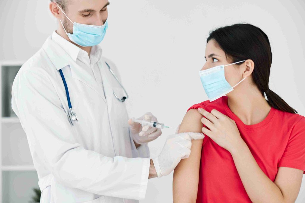 doctor giving a patient flu vaccine
