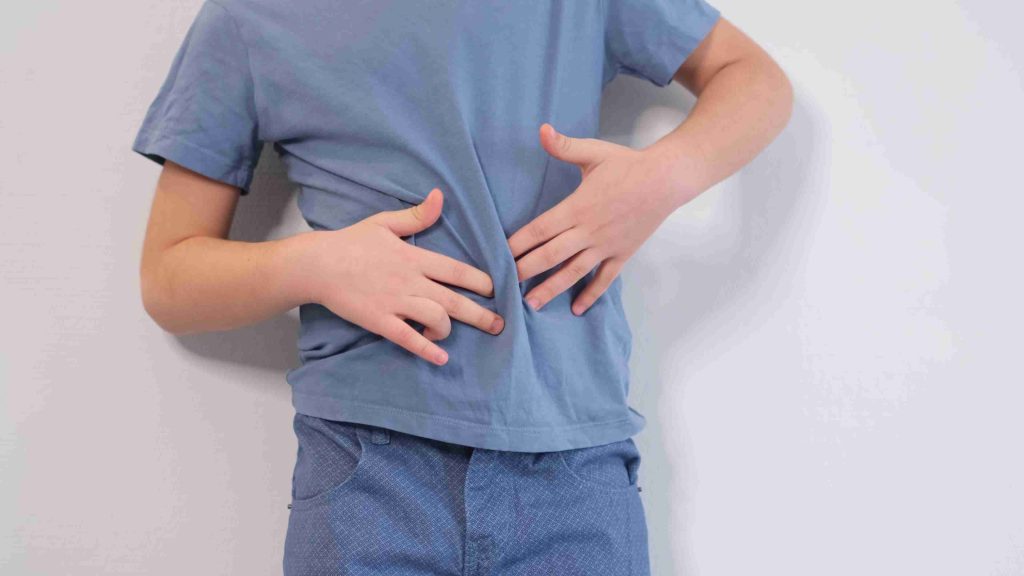 little boy with hands on his stomach