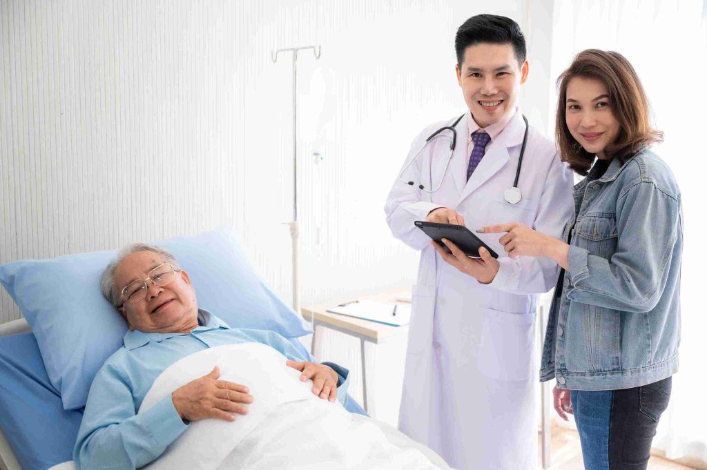 doctor visiting patient lying in the hospital bed