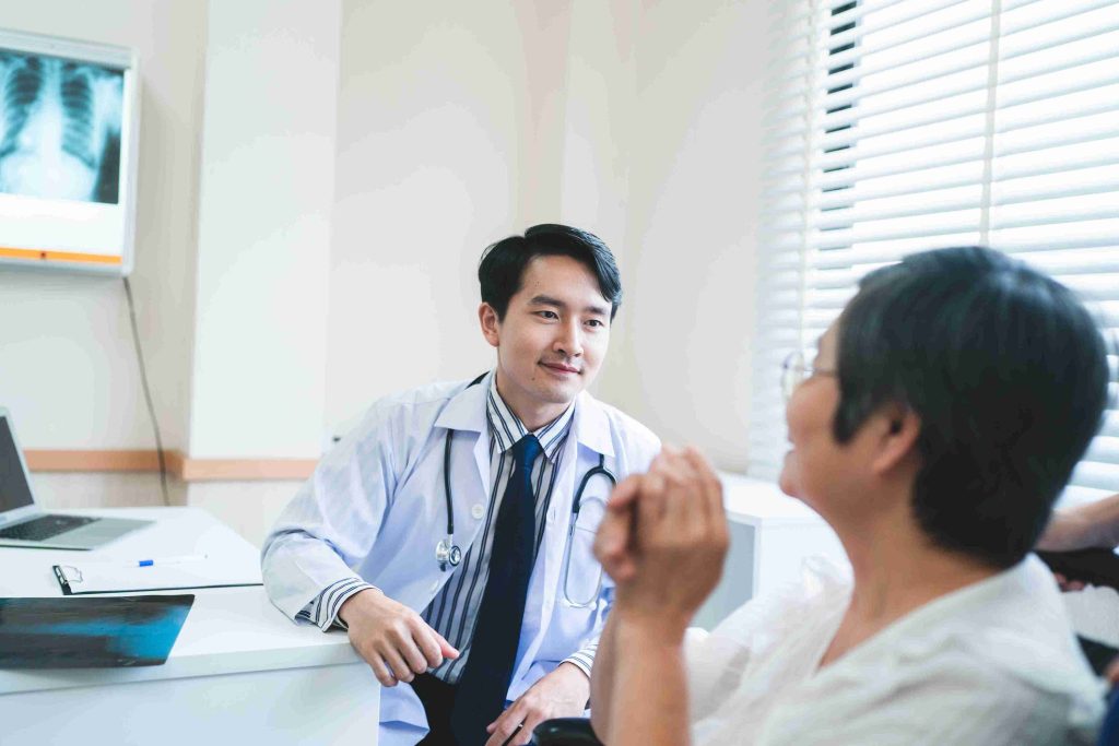 young doctor speaking with an elderly patient