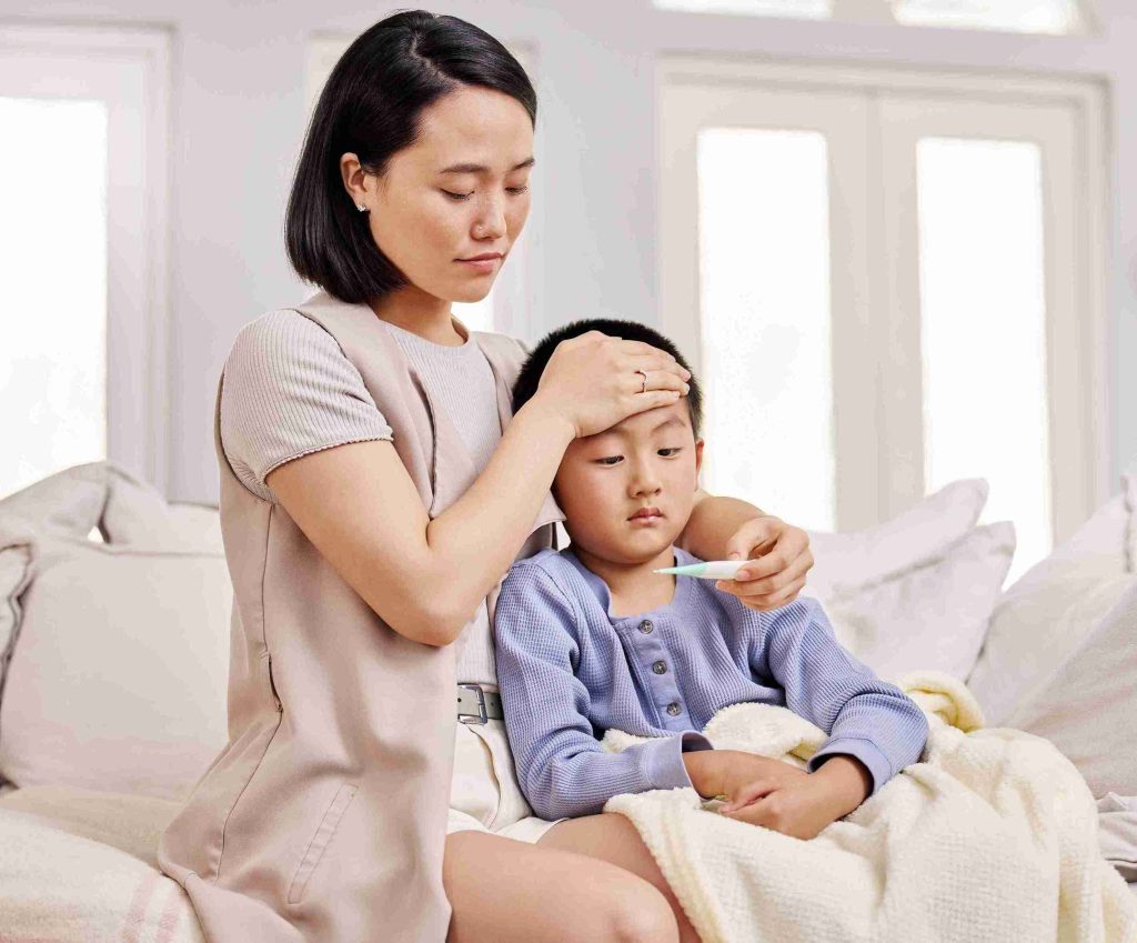 mother checking her child with fever
