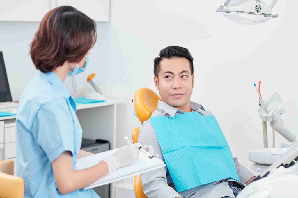 male asian patient visiting his dentist
