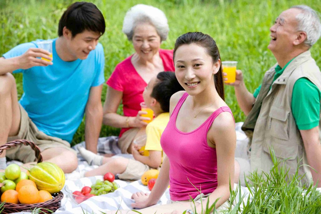 family eating healthy food outdoors