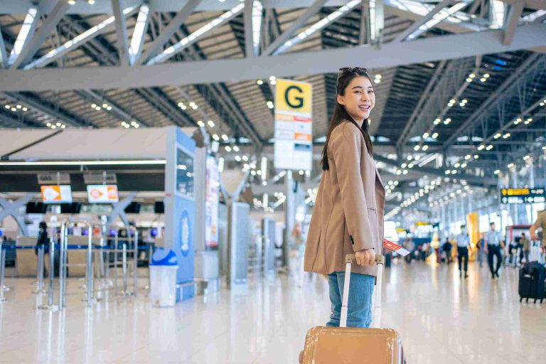 Young asian with her luggage in the airport.