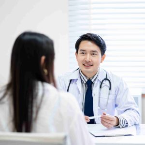 Doctor smiling and speaking with patient.