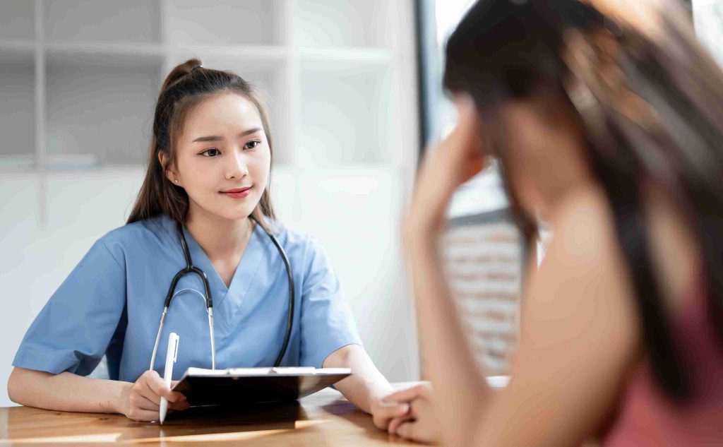 Female doctor smiling at a worried patient.