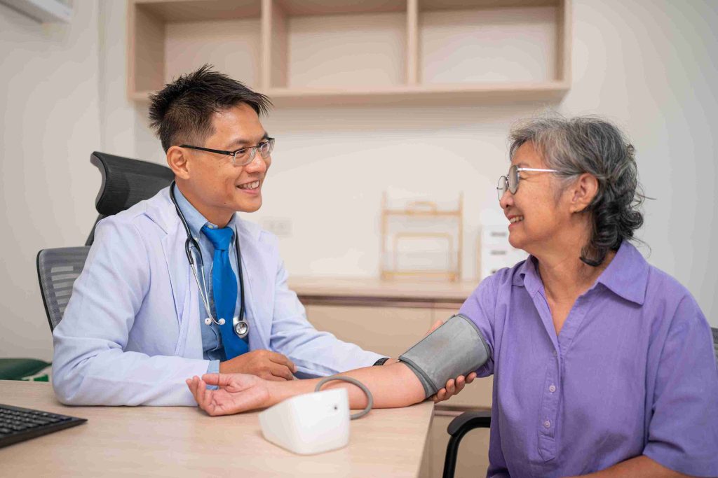 Doctor getting the blood pressure of an elderly patient.